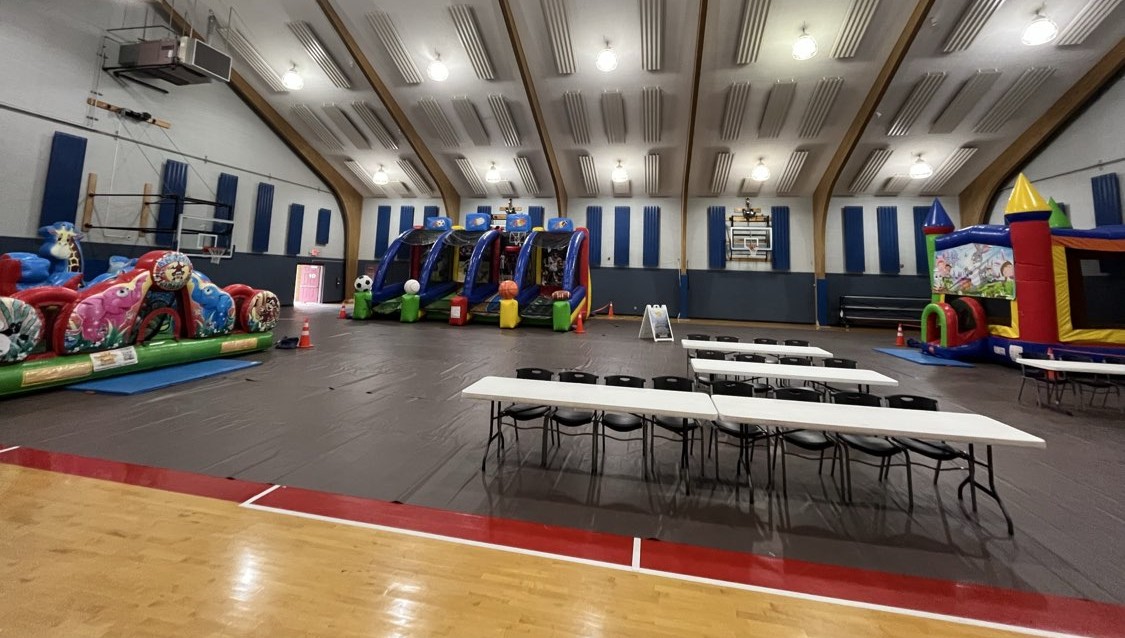 Gym set with long tables, chairs and inflatables